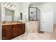 Bathroom with double vanity, granite countertops, and a tiled walk-in shower at 1096 W Via De Palmas --, San Tan Valley, AZ 85140