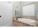 Bright bathroom with an oval soaking tub and granite tile surround near the window at 1096 W Via De Palmas --, San Tan Valley, AZ 85140