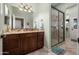 Bathroom with a granite vanity, framed mirror and glass-enclosed shower with tile surround at 1096 W Via De Palmas --, San Tan Valley, AZ 85140