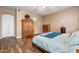 Bedroom with wooden floors and furniture, including a four-poster bed and dresser at 1096 W Via De Palmas --, San Tan Valley, AZ 85140