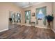 Bedroom with lots of light, wood floors, sheer curtains and a large mirrored closet at 1096 W Via De Palmas --, San Tan Valley, AZ 85140