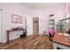 Bedroom with wood floors, light-pink walls, and ample lighting from a window at 1096 W Via De Palmas --, San Tan Valley, AZ 85140
