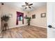 Comfortable bedroom with wood floors, ceiling fan, window and ample wall decor at 1096 W Via De Palmas --, San Tan Valley, AZ 85140
