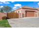 Long driveway leading to a home with a two-car garage and wood gate at 1096 W Via De Palmas --, San Tan Valley, AZ 85140