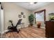 Well-lit exercise room with hardwood floors, fan, and decor at 1096 W Via De Palmas --, San Tan Valley, AZ 85140