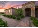 A charming single Gathering home featuring manicured landscaping, a stone facade, and a covered entry at 1096 W Via De Palmas --, San Tan Valley, AZ 85140