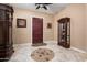 Elegant foyer featuring tile flooring, a decorative rug, a wooden door, and classic wooden furniture at 1096 W Via De Palmas --, San Tan Valley, AZ 85140