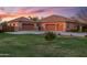 Lovely home showcasing a 3-car garage with an expansive green lawn at 1096 W Via De Palmas --, San Tan Valley, AZ 85140