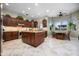 Beautiful kitchen with custom wood cabinets, granite countertops, an island, and a cozy breakfast nook at 1096 W Via De Palmas --, San Tan Valley, AZ 85140