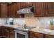 Well-equipped kitchen featuring wooden cabinets, granite countertops, and stainless steel appliances at 1096 W Via De Palmas --, San Tan Valley, AZ 85140