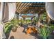 Inviting patio featuring a wooden pergola, flowing curtains, and a picnic table for outdoor enjoyment at 1096 W Via De Palmas --, San Tan Valley, AZ 85140