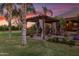 Backyard pergola with draperies, lounge seating, and beautiful landscaping at 1096 W Via De Palmas --, San Tan Valley, AZ 85140