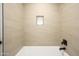 Modern tiled shower with a built-in niche and sleek black fixtures in an updated bathroom at 1120 W Barrow Dr, Chandler, AZ 85224