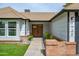 Charming single Gathering home entrance featuring brick accents, a well manicured lawn and an ADT security sign at 1120 W Barrow Dr, Chandler, AZ 85224
