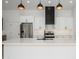 Contemporary kitchen island with stainless steel appliances, modern cabinetry, and pendant lights at 1120 W Barrow Dr, Chandler, AZ 85224