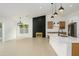 Bright open-concept living area with a decorative fireplace, kitchen, and ample natural light at 1120 W Barrow Dr, Chandler, AZ 85224
