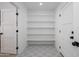 Walk-in pantry with ample shelving and a patterned floor, adjacent to two entry doors at 1120 W Barrow Dr, Chandler, AZ 85224