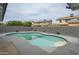 Swimming pool with a patio and gravel area, surrounded by a block wall and lush landscaping, making for a private oasis at 1120 W Barrow Dr, Chandler, AZ 85224