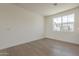 Bright bedroom with large window and light wood floors at 11300 N Casa Dega Dr # 1006, Surprise, AZ 85388