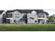 Newly built townhome with a modern exterior, lush front lawn, and manicured landscaping at 11300 N Casa Dega Dr # 1006, Surprise, AZ 85388