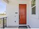 Inviting front entrance with a striking orange door and Toll Brothers welcome mat at 11300 N Casa Dega Dr # 1006, Surprise, AZ 85388