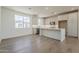 Modern, open kitchen with white cabinets, island, and stainless steel appliances at 11300 N Casa Dega Dr # 1006, Surprise, AZ 85388