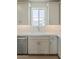 Bright kitchen features white cabinets, herringbone backsplash and stainless appliances at 11300 N Casa Dega Dr # 1006, Surprise, AZ 85388