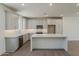 Bright kitchen features white cabinets, herringbone backsplash and stainless appliances at 11300 N Casa Dega Dr # 1006, Surprise, AZ 85388