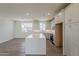 Open kitchen with island, white cabinets, and view to living area at 11300 N Casa Dega Dr # 1006, Surprise, AZ 85388