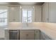 Bright kitchen features white cabinets, herringbone backsplash and stainless appliances at 11300 N Casa Dega Dr # 1006, Surprise, AZ 85388