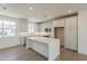 Open-concept kitchen featuring white cabinets, stainless appliances, and island at 11300 N Casa Dega Dr # 1006, Surprise, AZ 85388