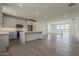 Open-concept kitchen featuring white cabinets, a quartz island, and modern appliances at 11300 N Casa Dega Dr # 1006, Surprise, AZ 85388