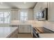 Bright kitchen features stainless appliances, white cabinets, quartz countertops and natural light at 11300 N Casa Dega Dr # 1006, Surprise, AZ 85388