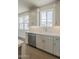 Bright kitchen features white cabinets, herringbone backsplash and stainless appliances at 11300 N Casa Dega Dr # 1006, Surprise, AZ 85388