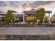Charming outdoor bar and dining area with ample seating, surrounded by trees and flowers at 11300 N Casa Dega Dr # 1006, Surprise, AZ 85388