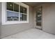Private balcony with a view of surrounding buildings through a window and glass door at 11300 N Casa Dega Dr # 1020, Surprise, AZ 85388