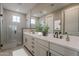 Elegant bathroom showcasing a double vanity with modern fixtures and glass-enclosed shower at 11300 N Casa Dega Dr # 1020, Surprise, AZ 85388