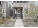 Inviting townhome entrance with small porch, metal gate, and manicured landscaping at 11300 N Casa Dega Dr # 1020, Surprise, AZ 85388