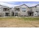 Charming townhome exterior with multiple levels, gray stucco, and a well-maintained lawn at 11300 N Casa Dega Dr # 1020, Surprise, AZ 85388
