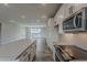 Sleek, contemporary kitchen with white subway tile backsplash, and modern stainless appliances at 11300 N Casa Dega Dr # 1020, Surprise, AZ 85388