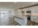 Modern kitchen features white cabinetry, stainless steel appliances, and a functional center island at 11300 N Casa Dega Dr # 1020, Surprise, AZ 85388