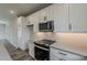 Close-up of a kitchen with white cabinets, stainless steel appliances, and subway tile backsplash at 11300 N Casa Dega Dr # 1020, Surprise, AZ 85388