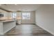 Open kitchen featuring white cabinets, gray quartz countertops, stainless steel appliances, and wood-look flooring at 11300 N Casa Dega Dr # 1020, Surprise, AZ 85388