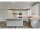 Modern kitchen with white cabinets, stainless steel appliances, and a large center island at 11300 N Casa Dega Dr # 1020, Surprise, AZ 85388