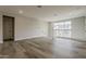 Open-concept living space with wood floors and natural light at 11300 N Casa Dega Dr # 1020, Surprise, AZ 85388