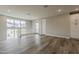 Bright loft area with light gray walls, wood-look flooring, a window with neighborhood views, and white cabinetry at 11300 N Casa Dega Dr # 1020, Surprise, AZ 85388