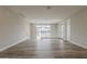 Open loft area with hardwood floors, white railing, and a view of the neighborhood outside at 11300 N Casa Dega Dr # 1020, Surprise, AZ 85388