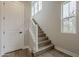 Bright staircase with wood treads, white risers, and natural light from a side window at 11300 N Casa Dega Dr # 1020, Surprise, AZ 85388