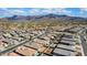 Scenic aerial shot capturing a meticulously planned community with mountain views and blue skies at 12047 E Sereno Rd, Gold Canyon, AZ 85118