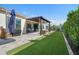 Inviting backyard features a covered patio, artificial turf and desert landscaping at 12047 E Sereno Rd, Gold Canyon, AZ 85118